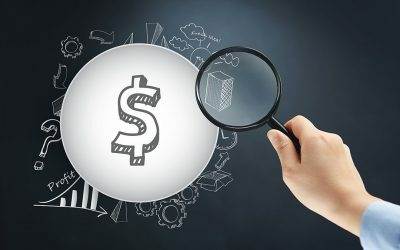 Image of a hand holding a magnifying glass to a dollar sign representing borrowing money for the best home loan with NBS Home Loans, Seven Hills, Sydney